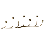 Brass candle holder with seven candle holders on a white background