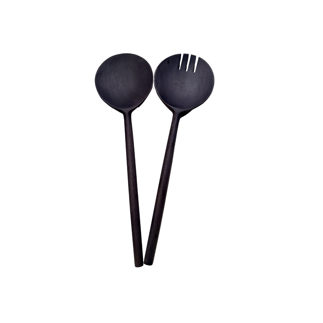Two dark brown wooden salad servers with different ends on a white background