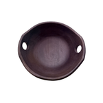 Dark brown wooden bowl with two holes on a white background