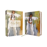 Open Bible with artistic cover design on a white background