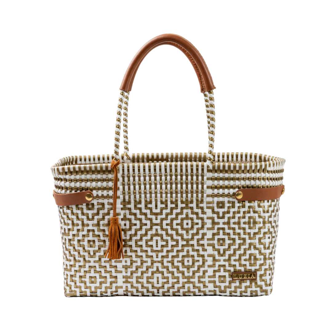 Woven handbag with geometric pattern and brown handles on a white background