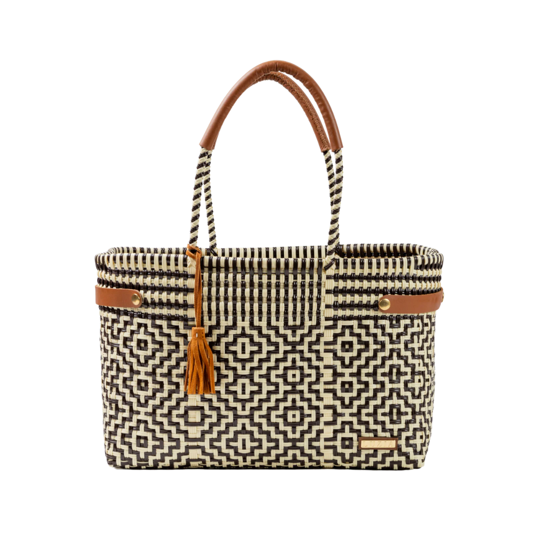 Woven handbag with geometric pattern and brown handle on a white background