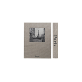 A storage box designed to look like a book featuring a black-and-white illustration of the Paris skyline, shown alongside a narrow matching strip with the text 'Paris' printed vertically.