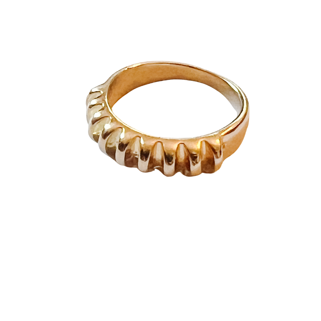 Gold ring with a textured design on a white background