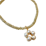 Moss green faceted beaded necklace with gold clasp and extender, shown worn alone and styled with a pearl charm pendant.