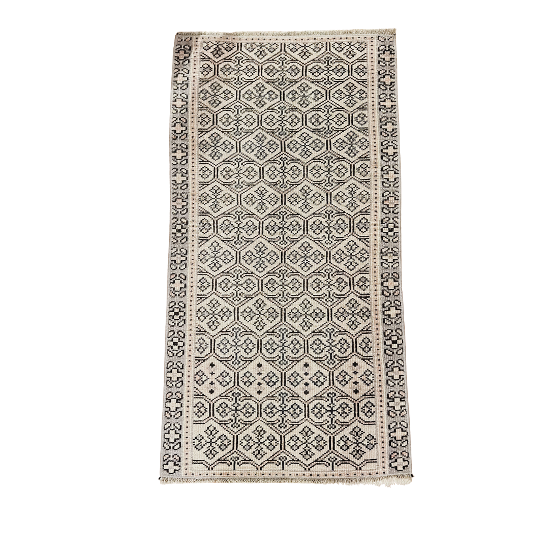 Patterned rug with geometric design on a white background