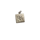Two-sided silver square charm featuring the number 41 on one side and a heart with a cross design on the reverse, photographed on a neutral background.
