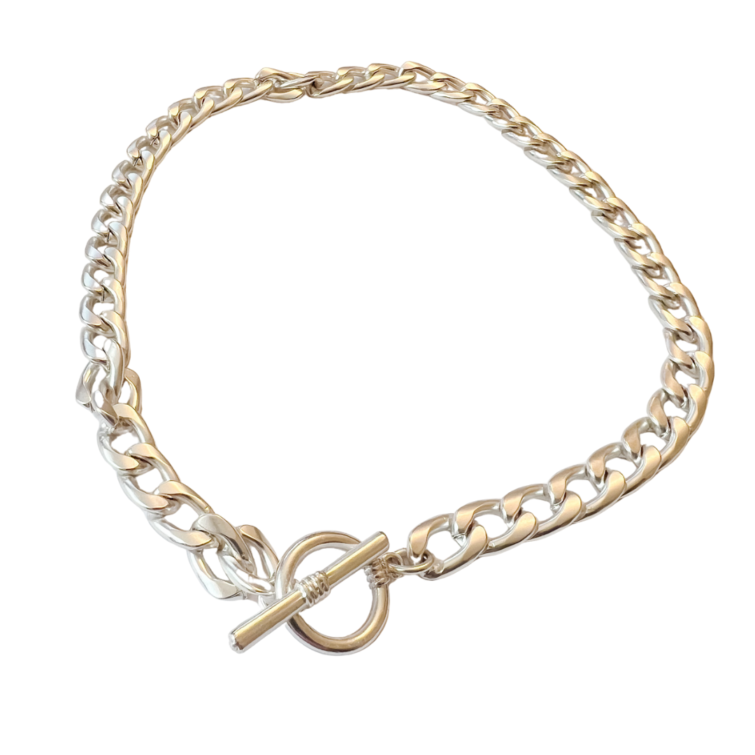 Gold and silver chain bracelet with a clasp on a white background