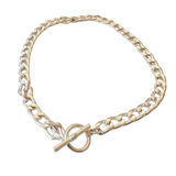 Gold and silver chain bracelet with a clasp on a white background