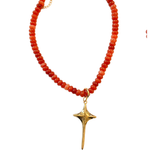 Necklace with red beads and a gold star-shaped pendant on a white background