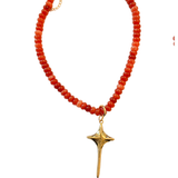 Necklace with red beads and a gold star-shaped pendant on a white background