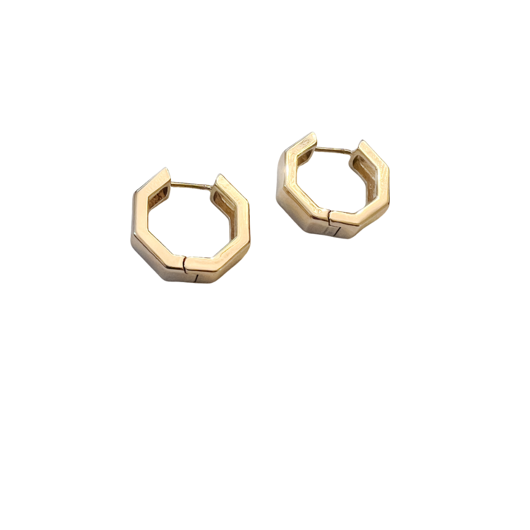 Gold hexagonal hoop earrings on a white background
