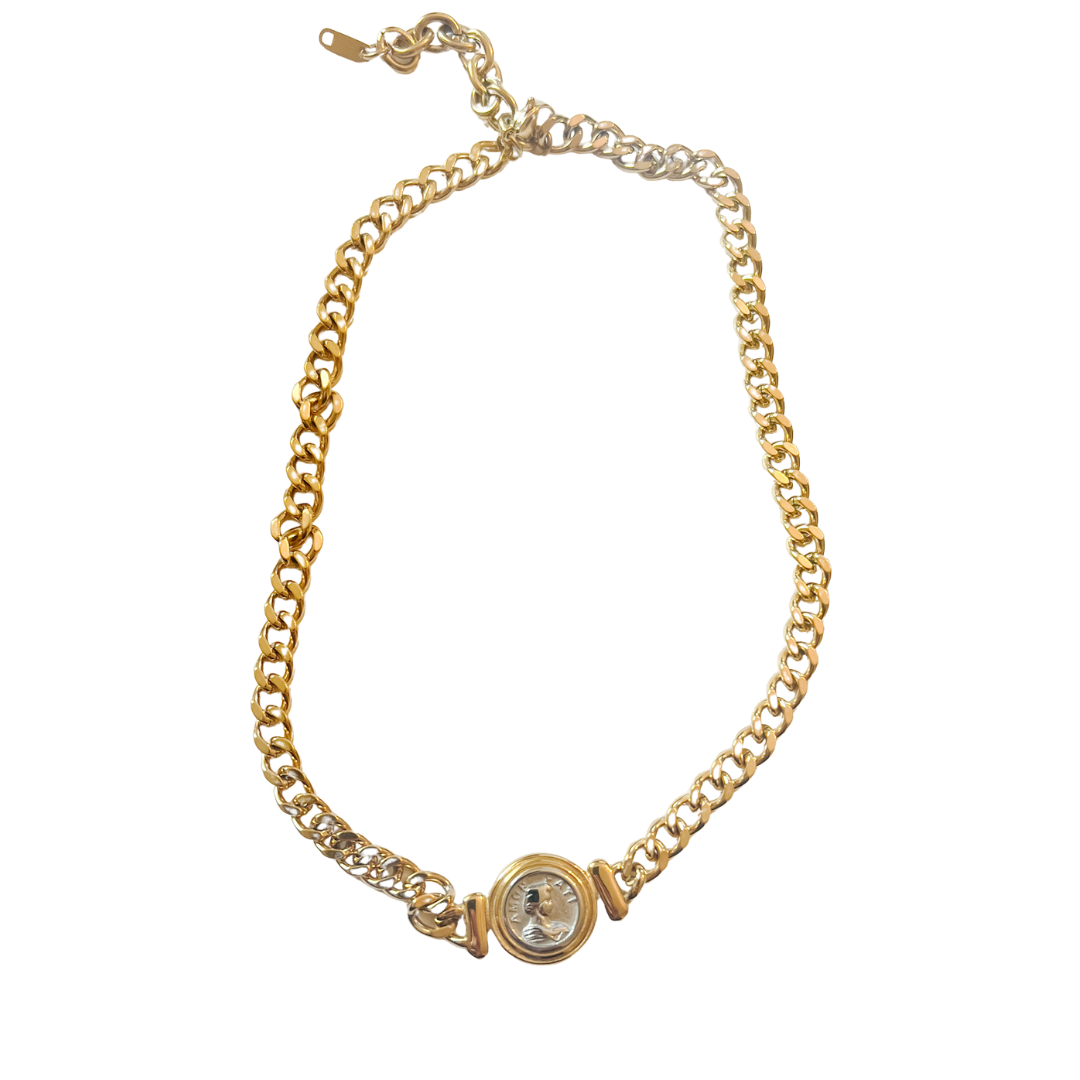 Gold chain bracelet with a watch face on a white background