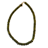 Green beaded necklace on a white background
