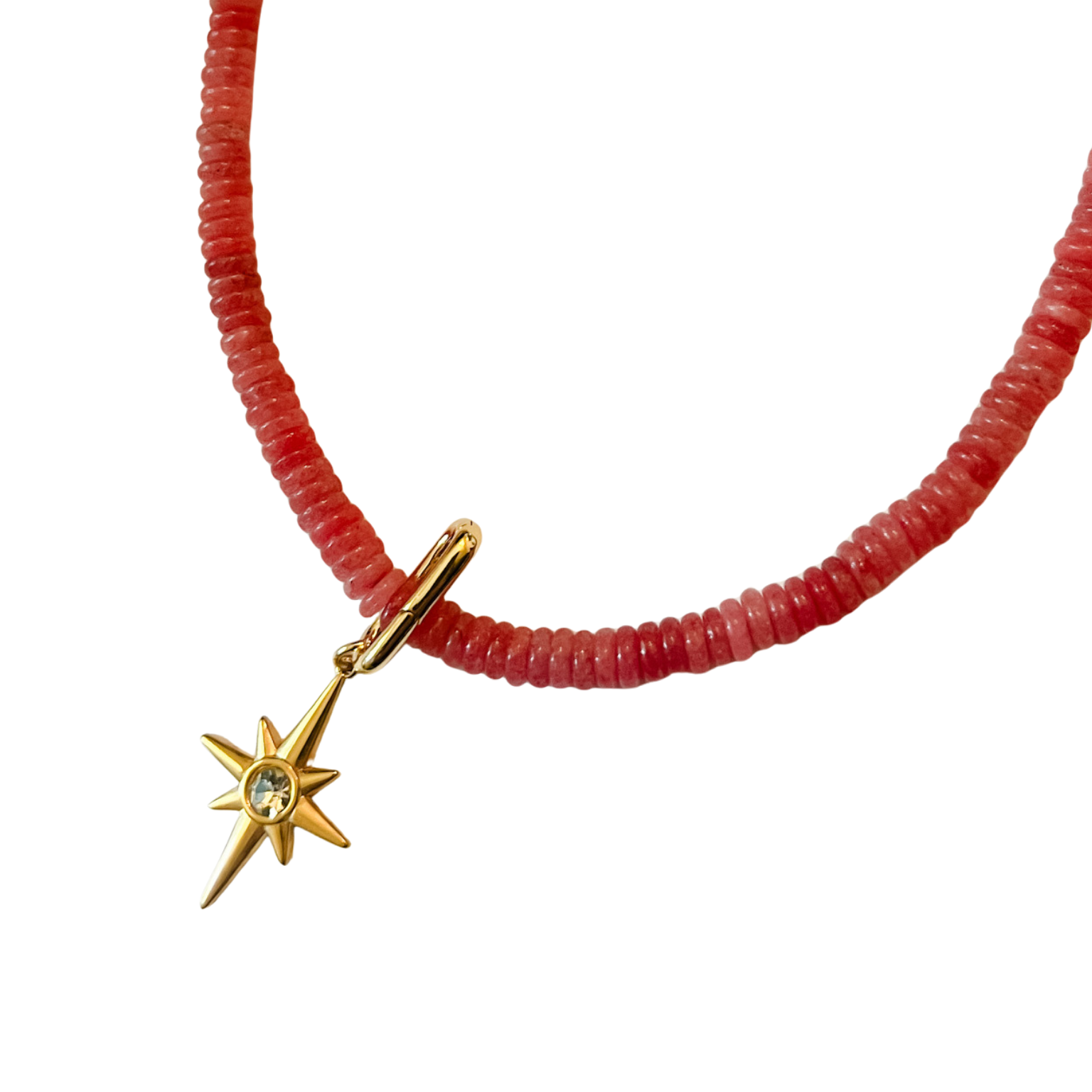 Pink faceted disc bead necklace with gold clasp and 2-inch extender, shown styled with a gold starburst charm on a white background.