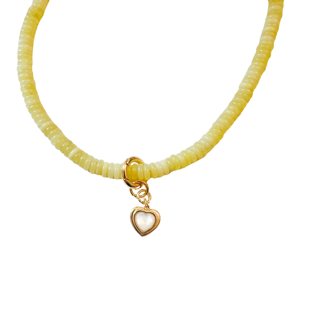 lime beaded necklace with a gold clasp and heart-shaped charm on a white background