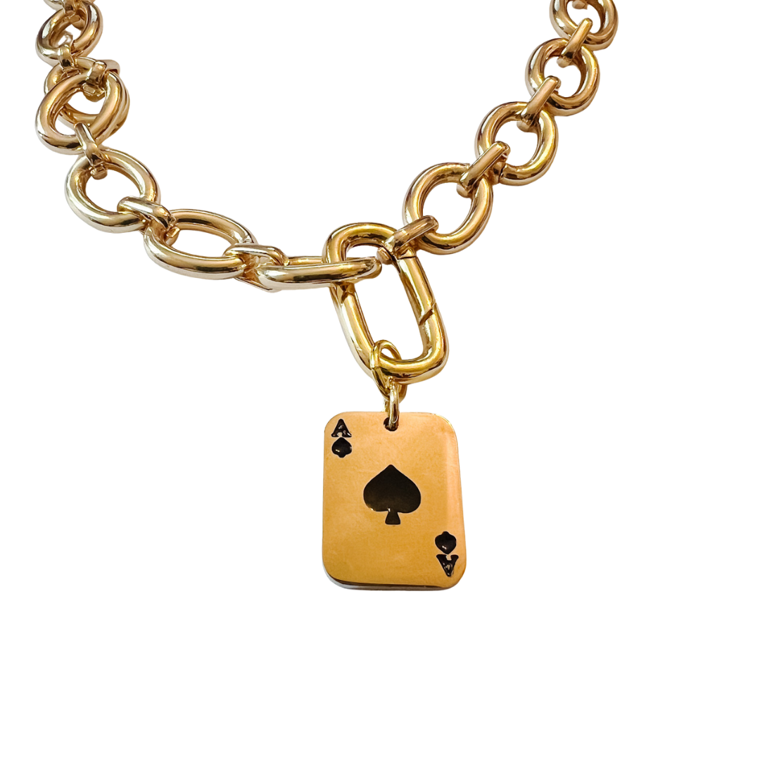 Gold oval link chain necklace with toggle clasp, shown styled with a gold playing card charm on a white background.