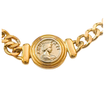 Gold chain bracelet with a coin charm on a white background