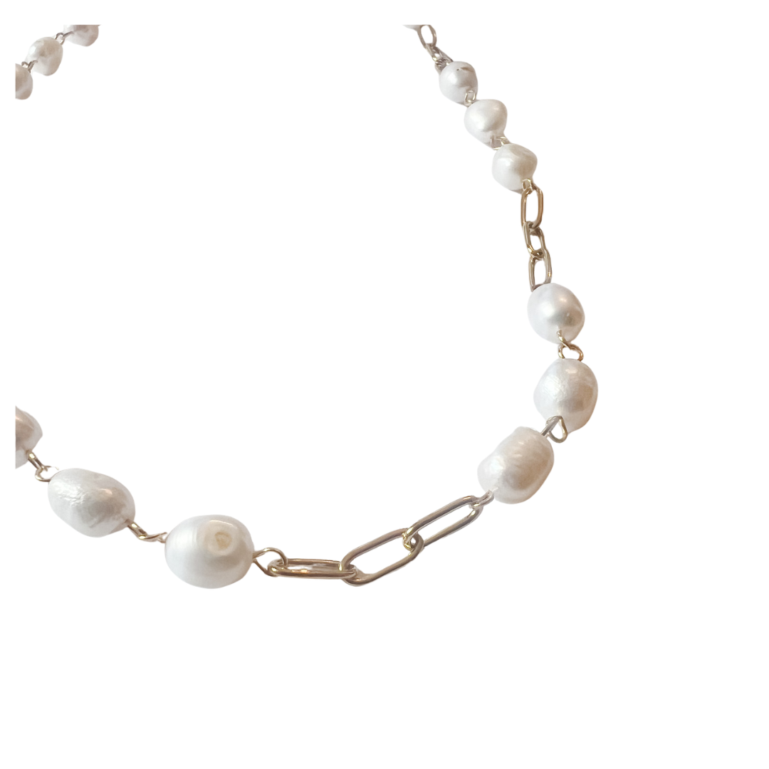 Freshwater pearl necklace with irregular white pearls and gold paperclip chain links, styled on a white background.