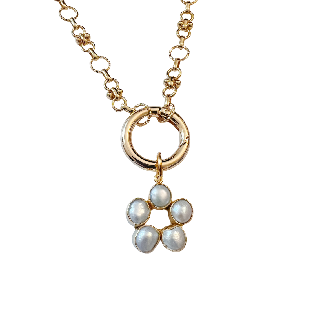 Gold necklace with a floral pendant featuring pearls on a white background