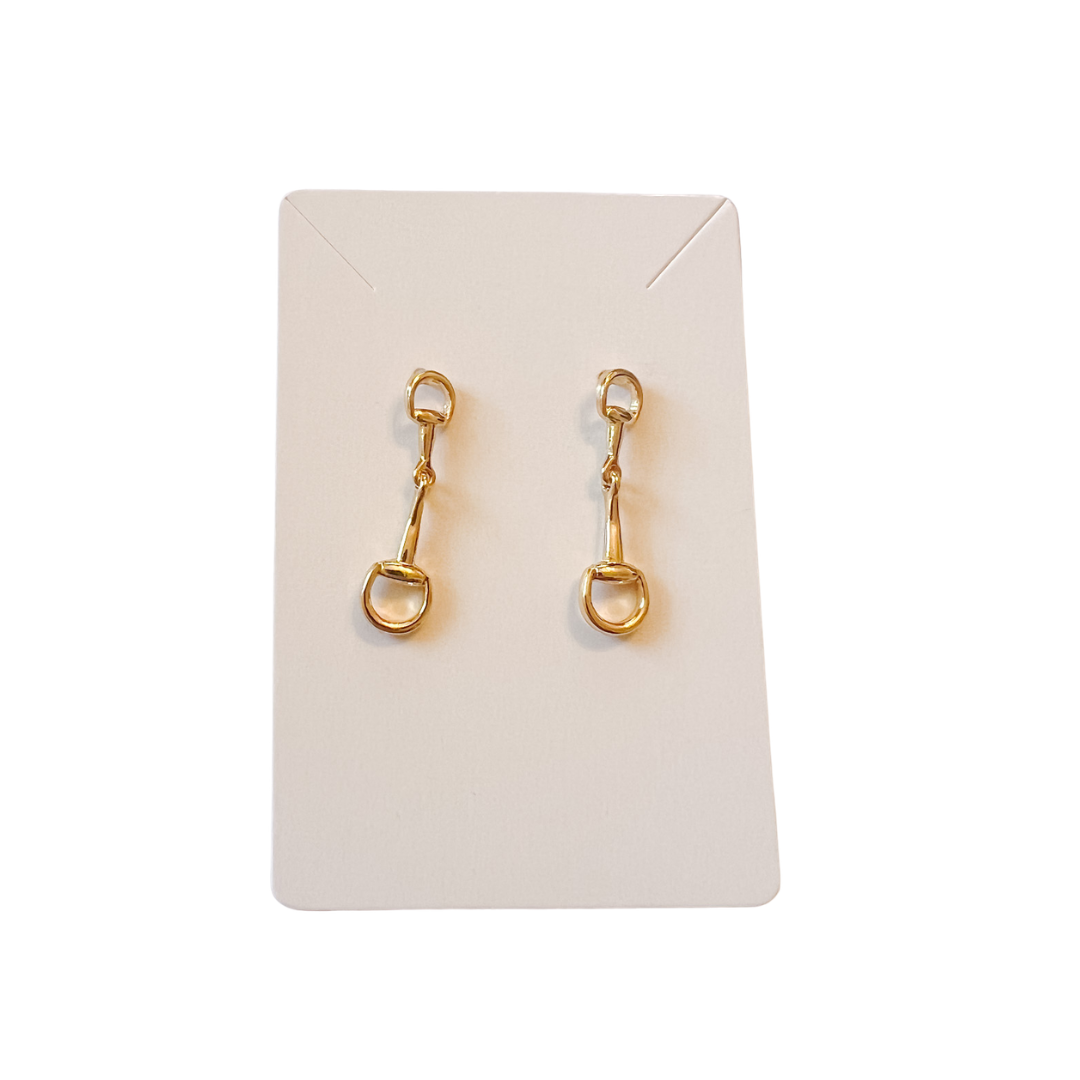Gold horse bit earrings on a white card