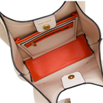 Open beige handbag with orange interior pocket, Montblanc logo visible.