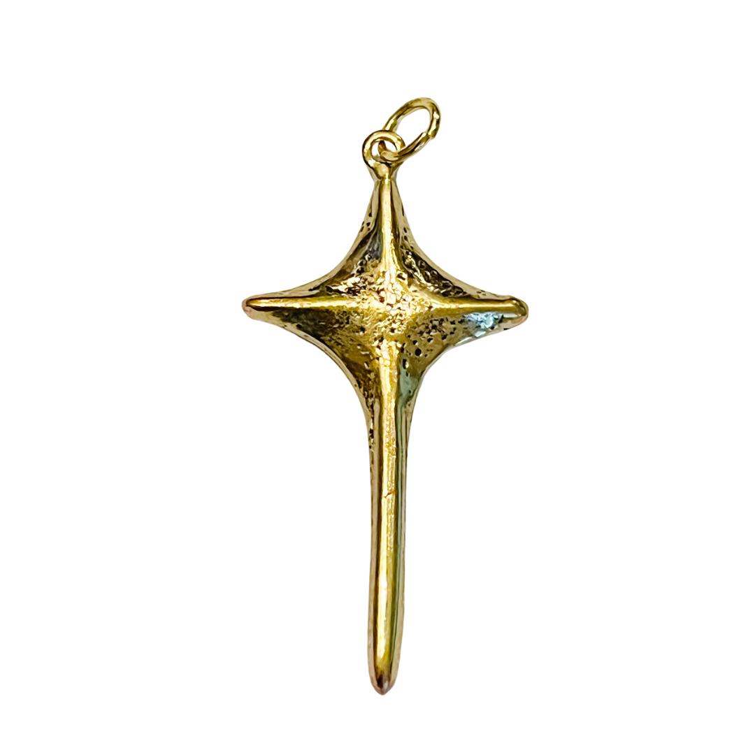 Gold pendant with a star-like design on a white background