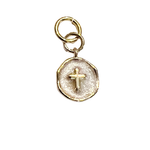 Small coin charm with raised gold cross and textured light-toned center on a white background.