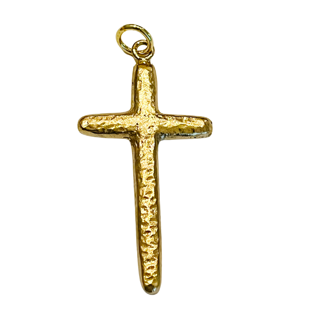 Gold hammered cross charm with textured finish on a white background.