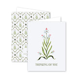 Greeting card with floral design and 'Thinking of You' text on a white background