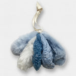 Blue and white scrunchies on a textured surface