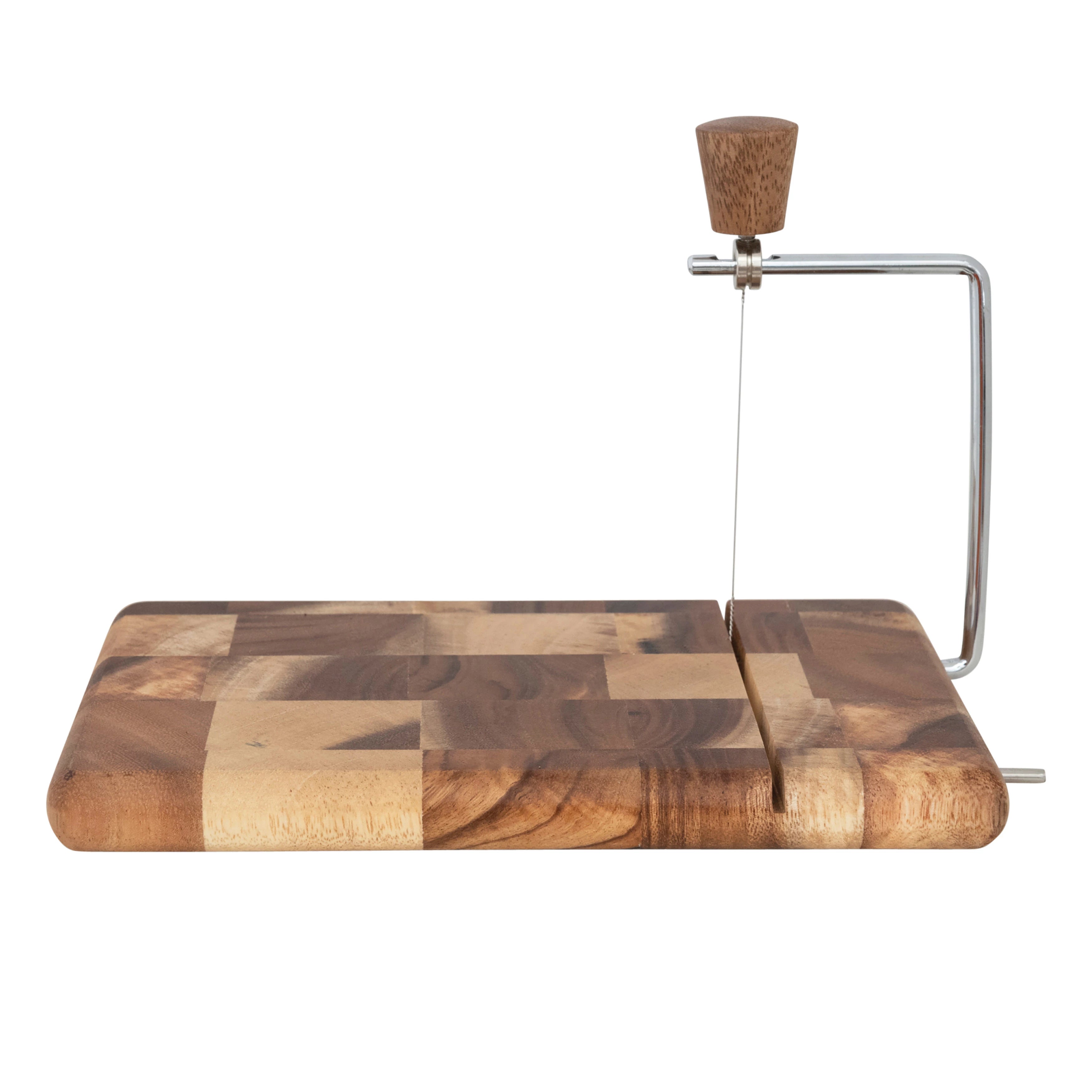 Wooden cutting board with a cheese slicer on a white background