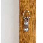 Wooden panel with a metal clip on a white background