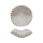 Two white ceramic coasters with textured designs on a white background