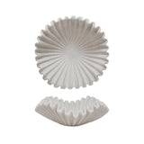Two white ceramic coasters with textured designs on a white background