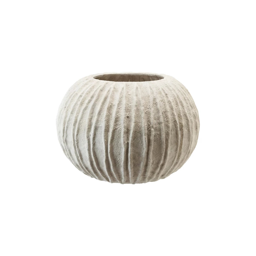 textured round white vase with ribbed design on white background