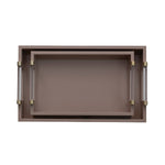 A rectangular tray with a warm taupe-brown finish and two clear acrylic handles with brass-colored end caps, shown against a plain white background.