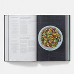 Open cookbook showing a recipe for stir-fried vegetables on a white background