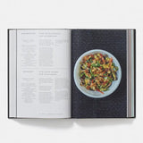 Open cookbook showing a recipe for stir-fried vegetables on a white background