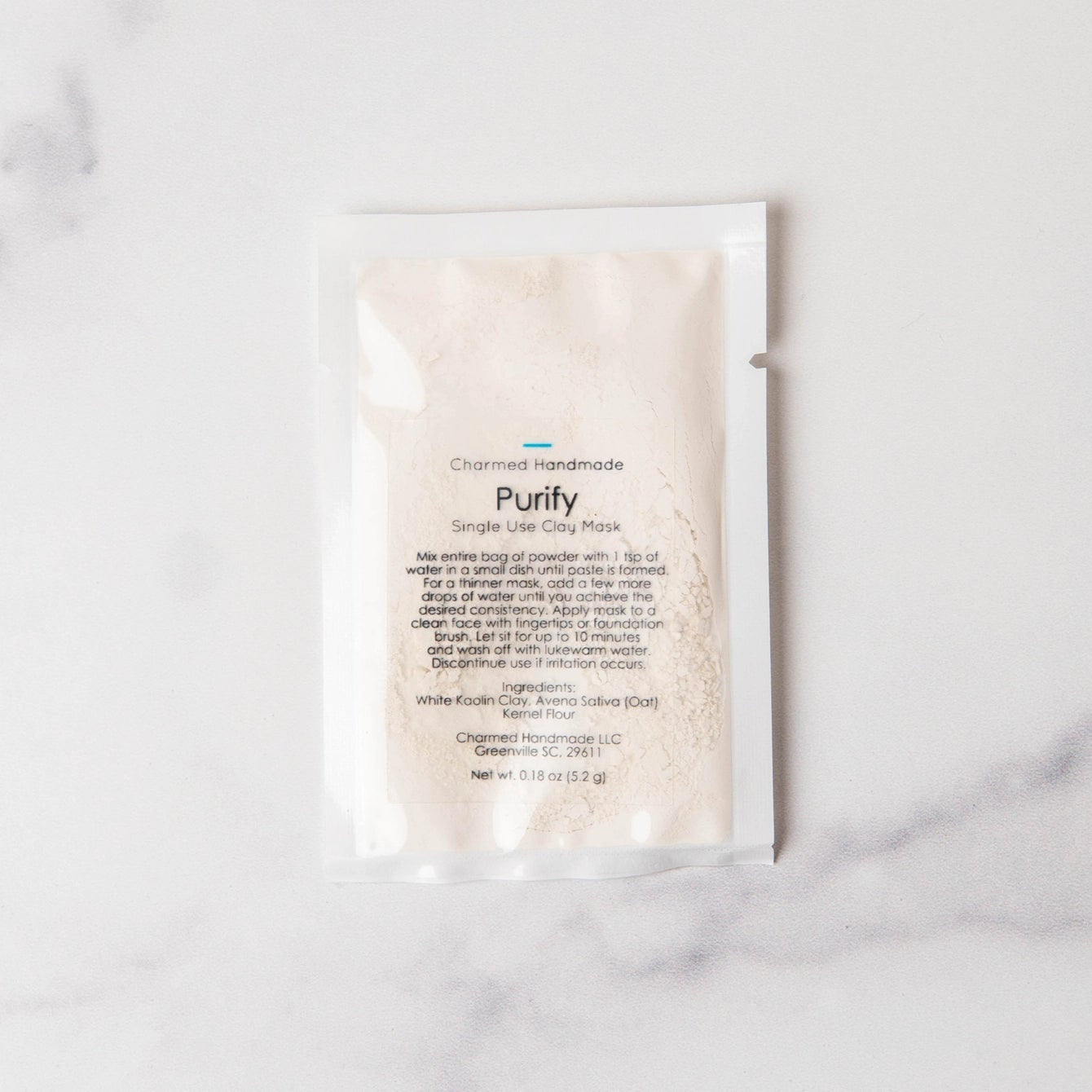 Skincare product packaging labeled 'Purify' on a marble surface