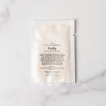 Skincare product packaging labeled 'Purify' on a marble surface