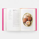 Open book with a plate of cookies on a white background