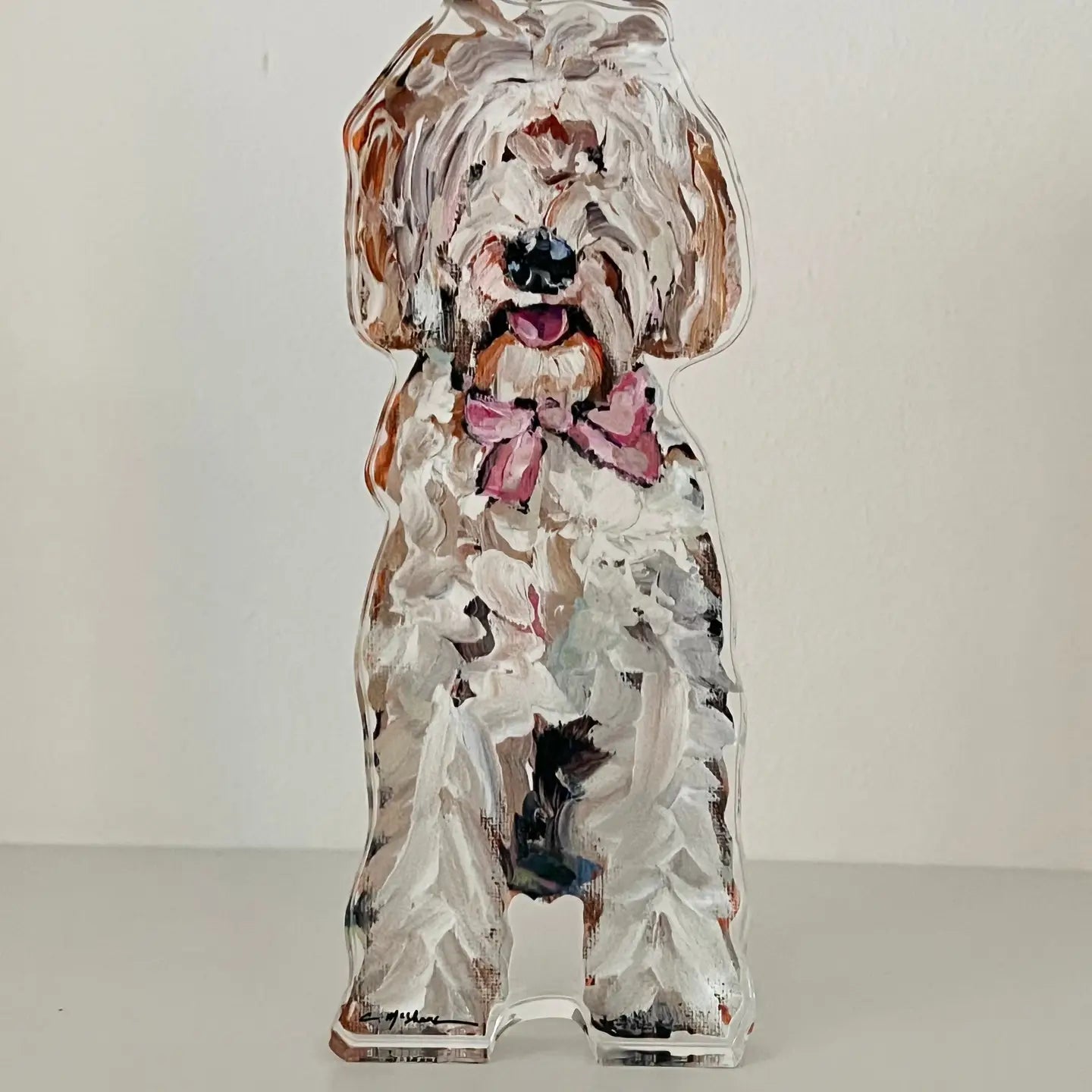Decorative dog-shaped object with a bow on a white background