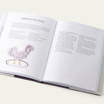 Open Bergdorf Goodman Cookbook book with a recipe for Chicken Milanese on a white background