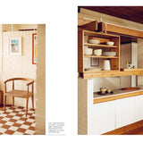 Modern kitchen with wooden shelves and white cabinets, featuring a chair and checkered floor.