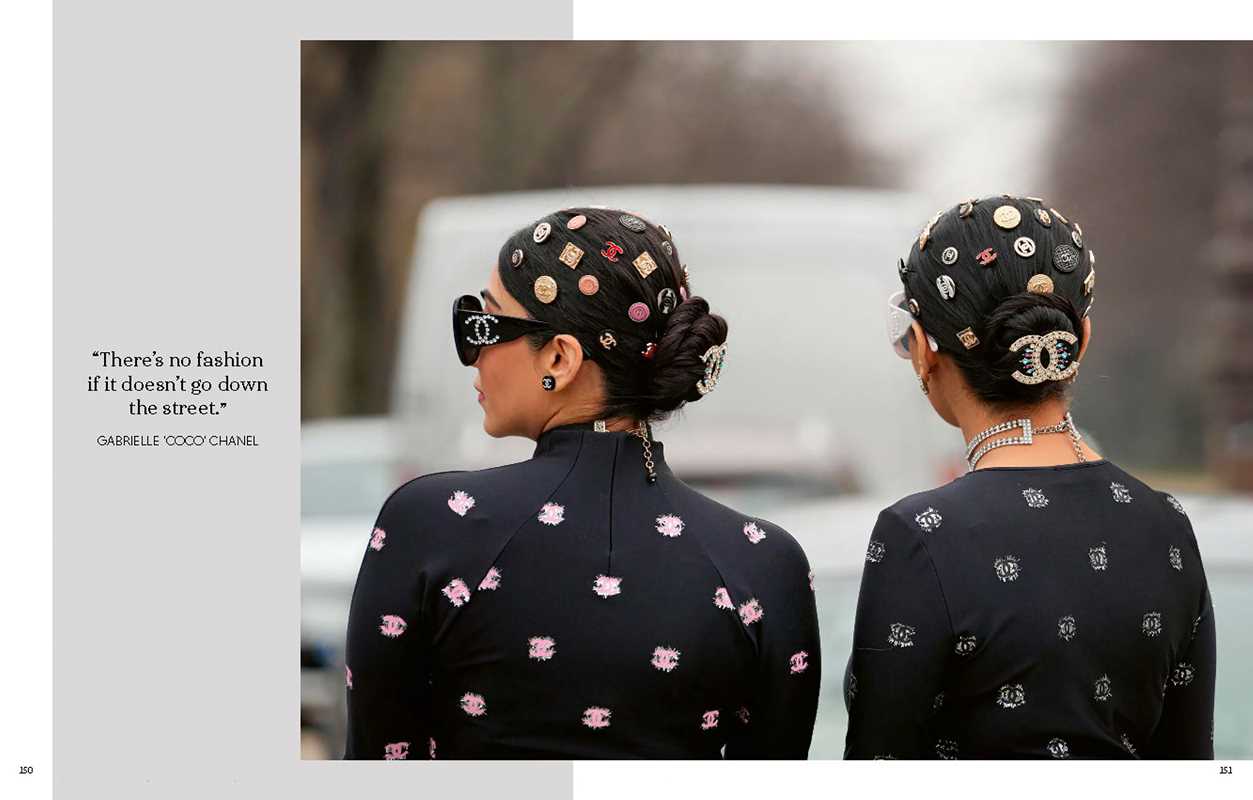 Two women wearing black outfits with floral patterns and Chanel headscarves, with a blurred background.