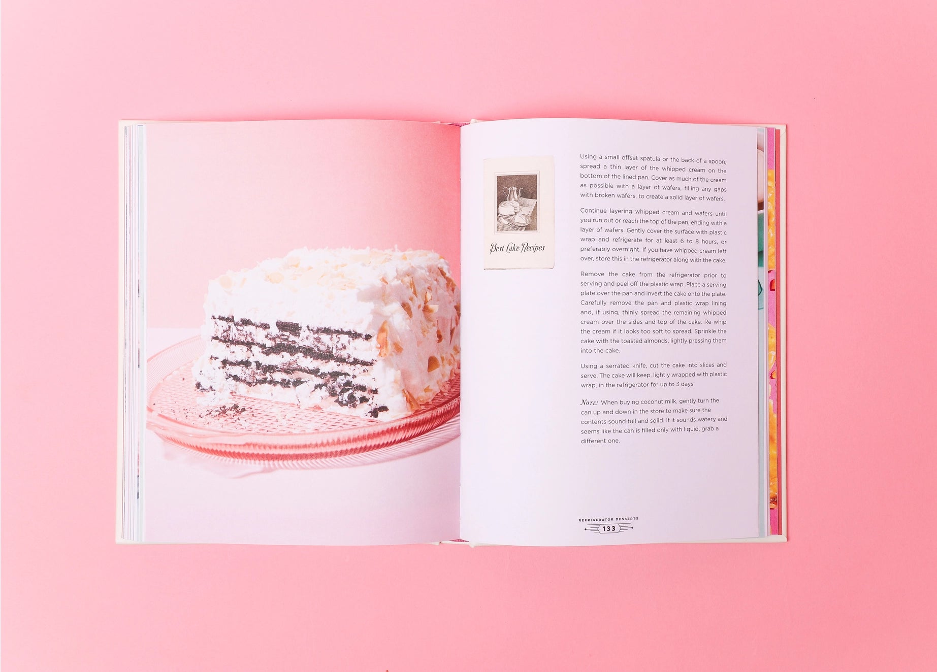 Open book with a cake illustration on a pink background