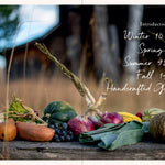 Assorted vegetables on a wooden surface with a blurred natural background