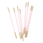 Set of pink and gold pens on a white background