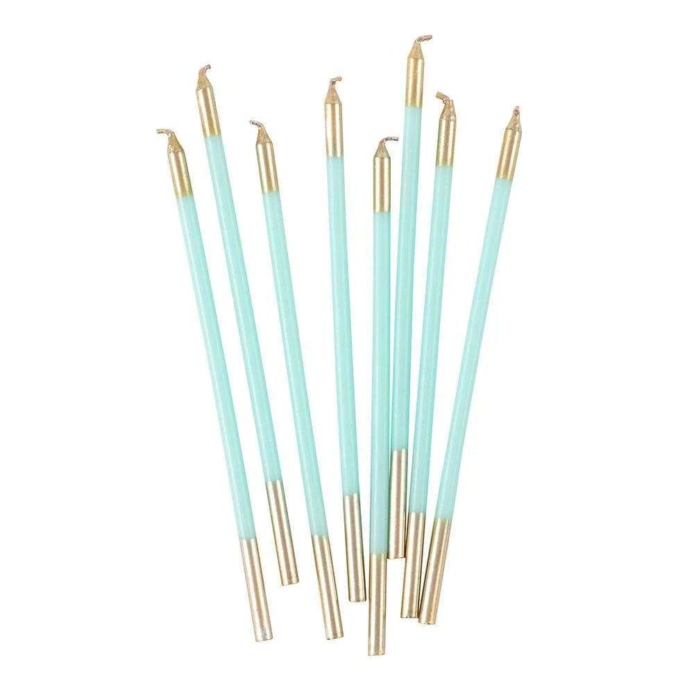 Set of light blue and gold makeup brushes on a white background
